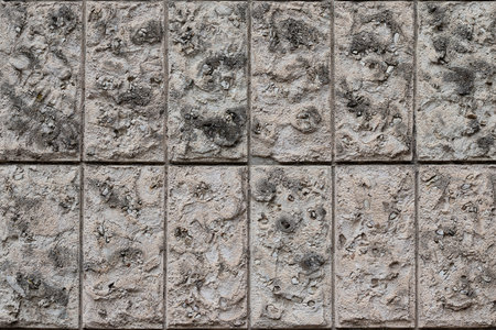 Natural stone wall vertical blocks. The texture of the stone lined with blocks of natural limestone...