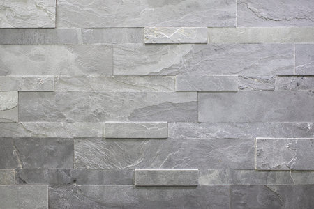 Natural stone, smooth linear masonry, gray relief texture. The wall is made of stone, the surface is...