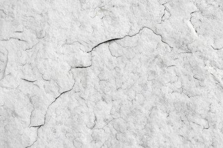 The texture of natural white granite stone with cracks. Background of natural stone gray. Texture with a small crack.の写真素材