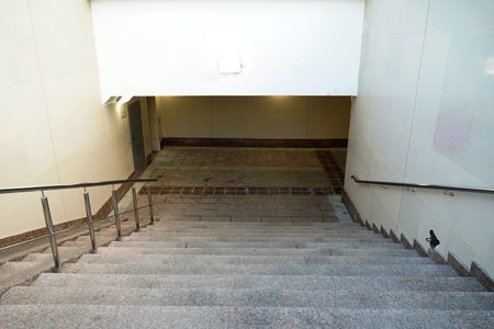 Modern descent to the pedestrian tunnel is empty without people. Stairway down to the underground...