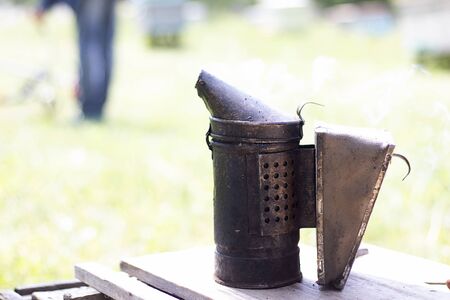 Tool for smoking bees from the hive. Smoke for bees, work on the apiary. Beekeeping natural honey.の写真素材