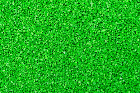 Green textural background. Lawn surface or fine texture for a playground. Close-up texture.