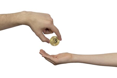 Cryptocurrency Inheritance Concept. The hand of an adult transfers gold bitcoin to the childâs hand. Inheritance, translation, payment.の写真素材