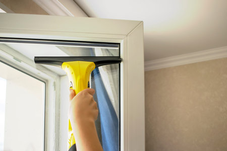 Wash the window at home with a battery wiper. The apparatus yellow collects drops of water and clean...