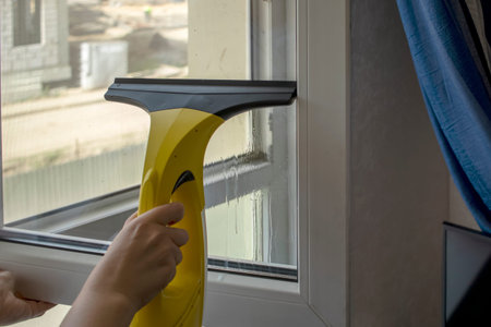 Wash the window at home with a battery wiper. The apparatus yellow collects drops of water and clean...
