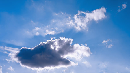 The bright sun breaks through the white cloud, the rays of the sun break through. Blue bright clear...