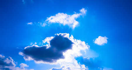The bright sun breaks through the white cloud, the rays of the sun break through. Blue bright clear...