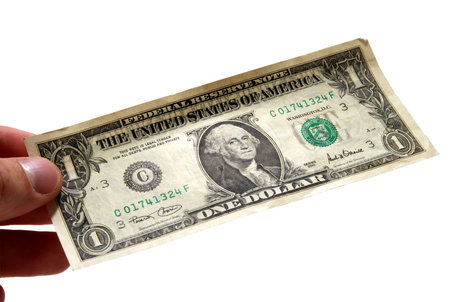 Hand holding one dollar bill