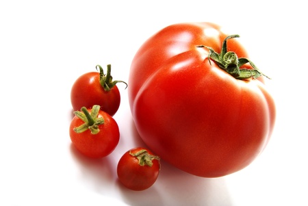 One big and three small tomatoes.の写真素材