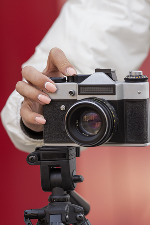 the girl in the hands of is holding the vintage cameraの写真素材