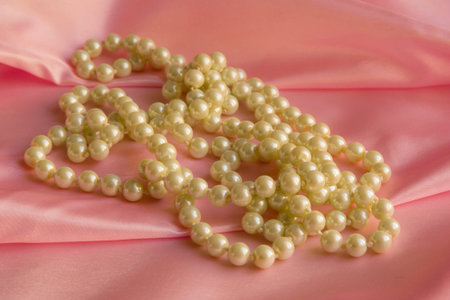 Pearl Necklace on delicate Pink silk background
