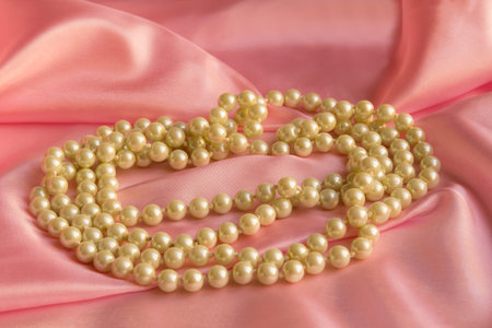 Pearl Necklace on delicate Pink silk background