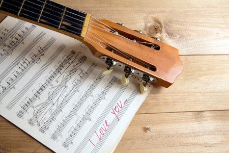 acoustic guitar and musical notes on a table