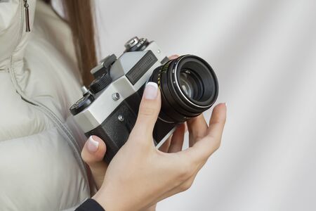 the girl with the French manicure is holding the vintage cameraの写真素材