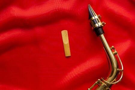 wooden Reeds and saxophone mouthpiece on a red backgroundの写真素材