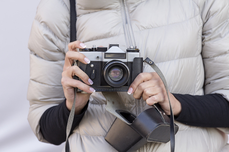 the girl with the French manicure is holding the vintage cameraの写真素材
