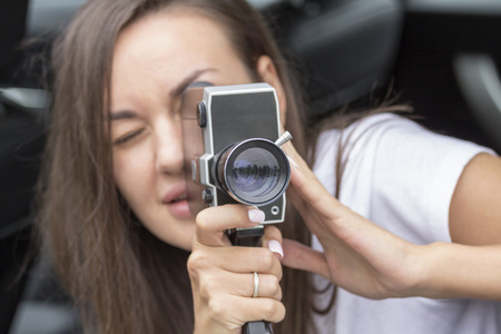 beautiful girl shoots movies old film cameraの写真素材