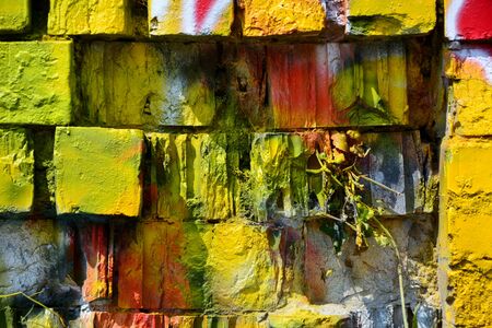 Old grunge stone wall with colorful graffitiのeditorial素材