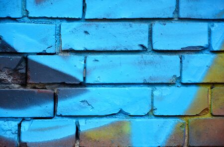 Old brick wall with colorful graffitiの写真素材
