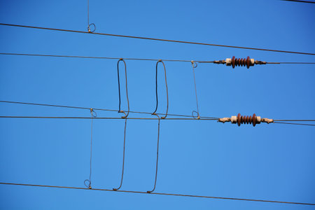 Industrial high voltage power cables against blue sky