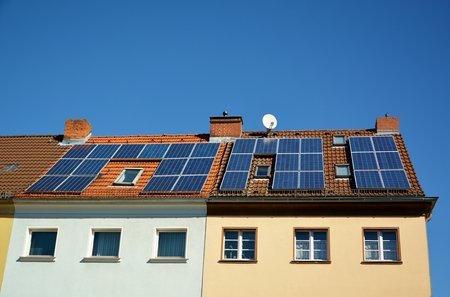 Ecological and renewable solar energy panels on the roof of a houseの写真素材