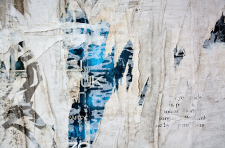 Colorful torn posters on grunge old walls as creative and abstract background