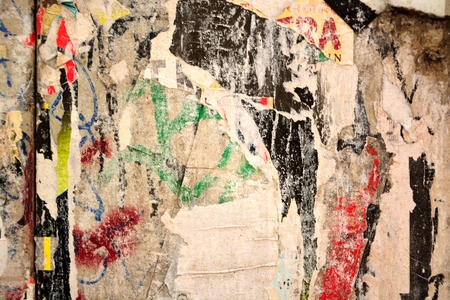 Colorful torn posters on grunge old walls as creative and abstract backgroundの写真素材