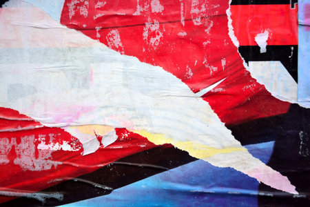 Colorful torn posters on grunge old walls as creative and abstract backgroundの写真素材