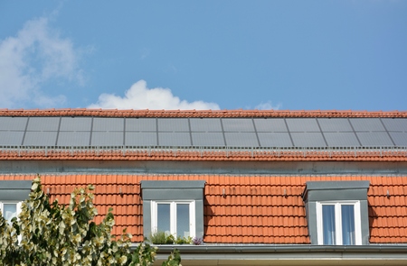 Ecological and renewable solar energy panels on the roof of a houseの写真素材