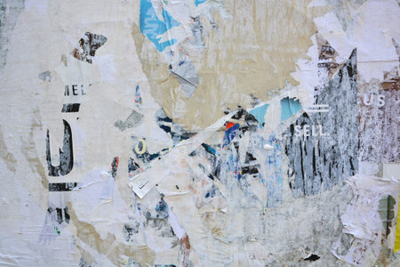Colorful torn posters on grunge old walls as creative and abstract backgroundの写真素材