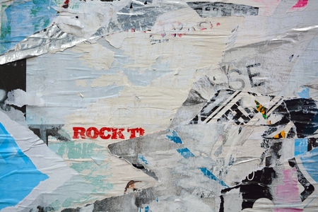 Colorful torn posters on grunge old walls as creative and abstract backgroundの写真素材