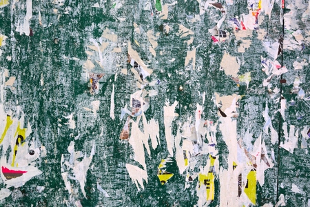 Colorful torn posters on grunge old walls as creative and abstract backgroundの写真素材