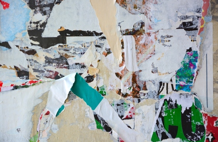Colorful torn posters on grunge old walls as creative and abstract backgroundの写真素材