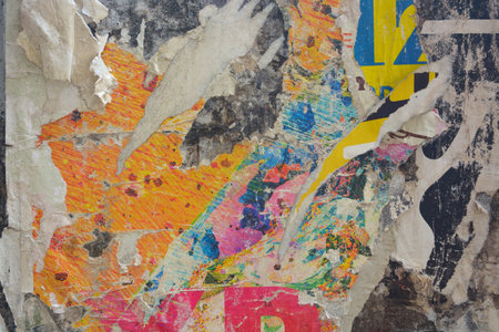 Colorful torn posters on grunge old walls as creative and abstract background