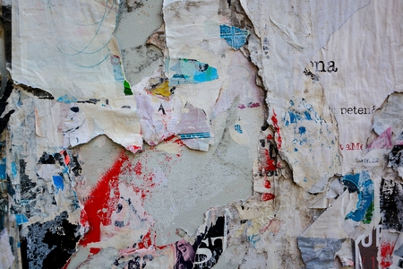 Colorful torn posters on grunge old walls as creative and abstract backgroundの写真素材