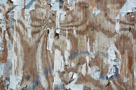 Colorful torn posters on grunge old walls as creative and abstract background