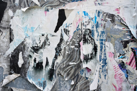 Colorful torn posters on grunge old walls as creative and abstract backgroundの写真素材