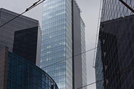 Cityscape with fragments of tall buildings in blue and gray colorsの写真素材