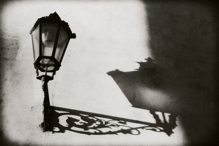 Prague, Czech Republic: Not a lighted lantern on the wall. From him on the wall pronounced shadow and outlines.の写真素材