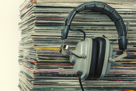 Audiophile headphones and a stack of old vinyl records.Toned photo.の写真素材