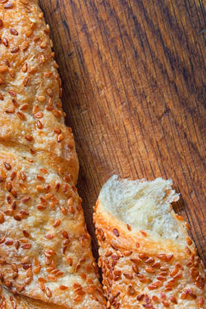 Wheat bread with sesame on  a wooden boardの写真素材