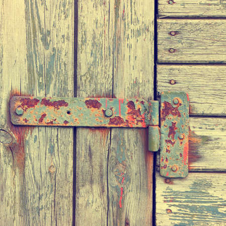 Metallic loop on an old wooden doorの写真素材