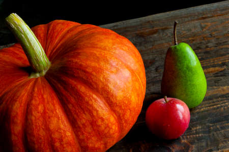 Pumpkin, pear and apple on the tableの写真素材