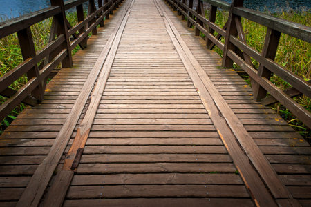 Wooden bridge over the river in the countrysideの写真素材