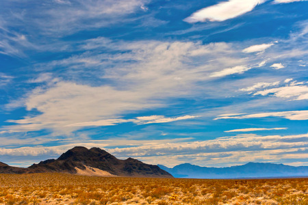 Mountains, the desert and clouds on a summer dayの写真素材