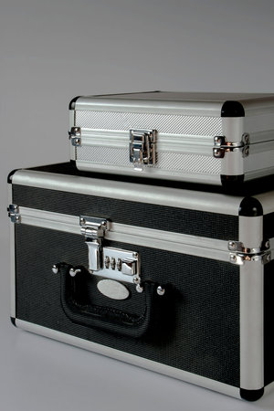 Two metallic briefcase on a gray background