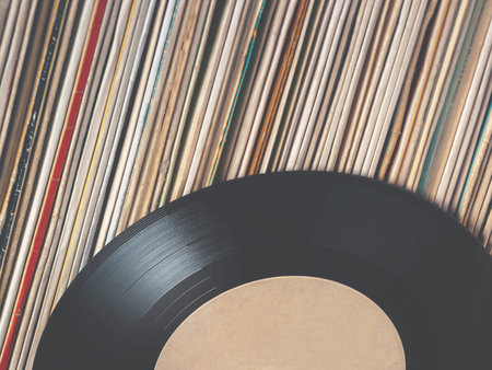 Many old vinyl plates stand in a row
