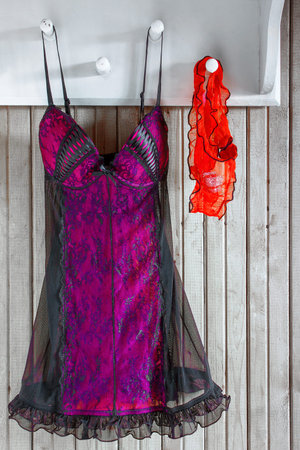 Women's underwear hanging on an old wooden hangerの写真素材