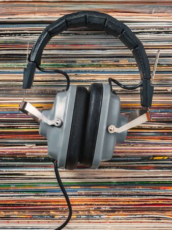 Audiophile headphones and a stack of old vinyl recordsの写真素材