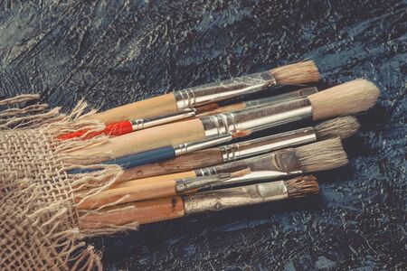 Brushes for painting lie on the palette in the artist's studioの写真素材